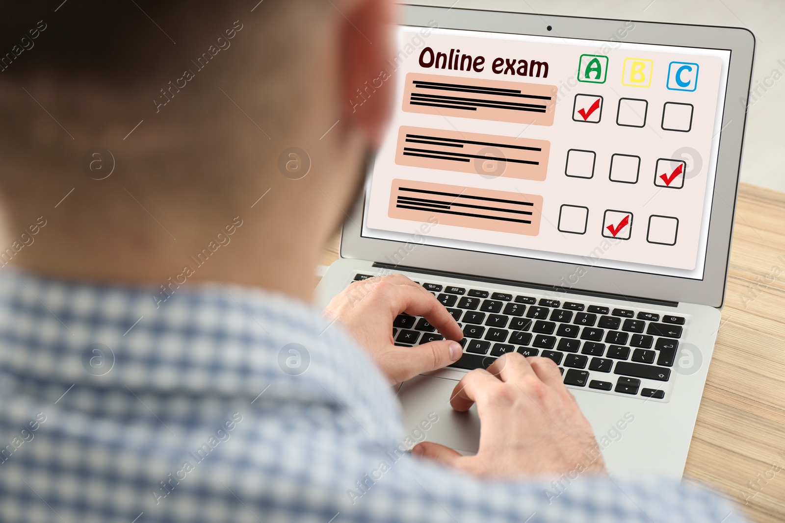 Image of Student passing online exam at wooden table, closeup