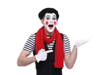 Photo of Mime artist making shocked face and pointing at something on white background