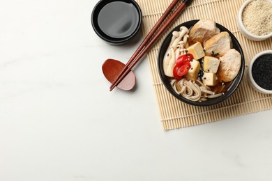 Delicious ramen served on white marble table, flat lay with space for text. Noodle soup