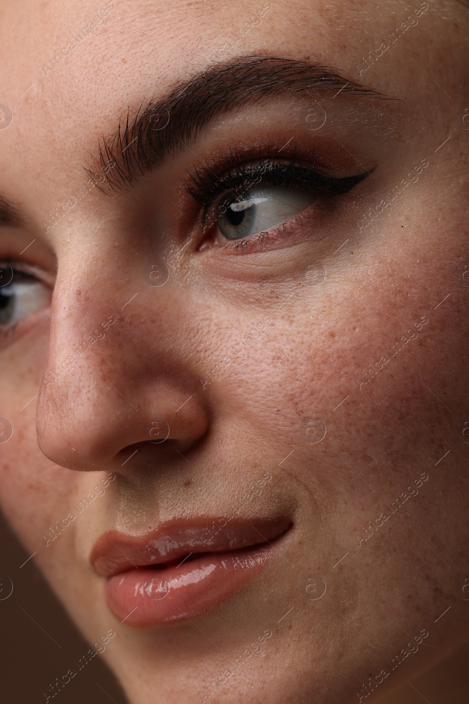 Photo of Beautiful woman with makeup and fake freckles, closeup