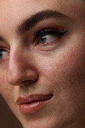 Photo of Beautiful woman with makeup and fake freckles, closeup