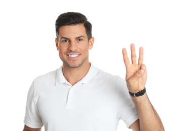 Photo of Man showing number three with his hand on white background