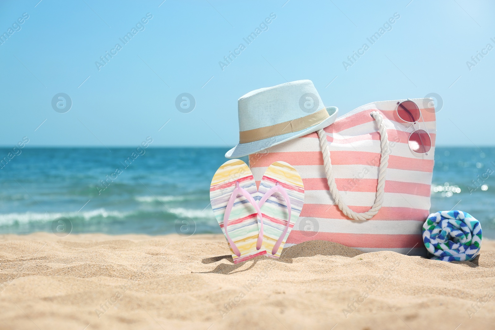 Photo of Set of different beach objects on sand near sea. Space for text