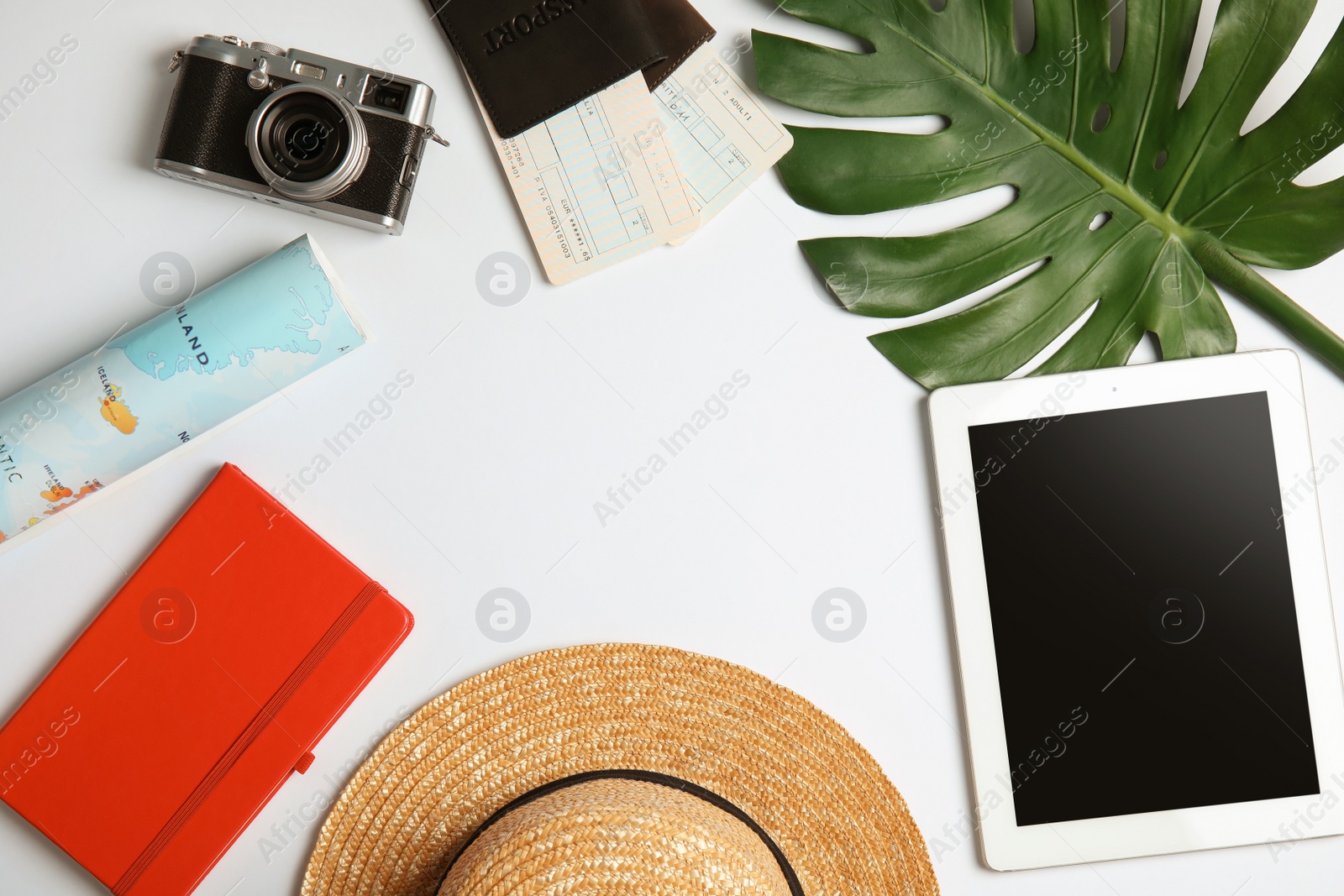 Photo of Flat lay composition with tourist items and tablet computer on white background, space for text. Travel agency