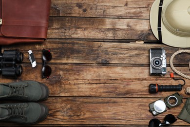 Photo of Flat lay composition with different safari accessories on wooden background. Space for text