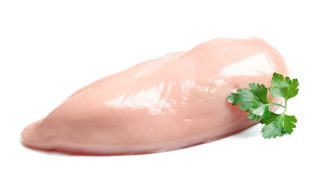 Photo of Raw chicken breast with parsley on white background