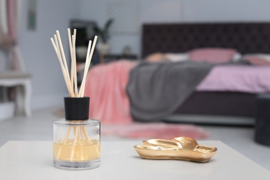 Photo of Reed freshener on table in bedroom