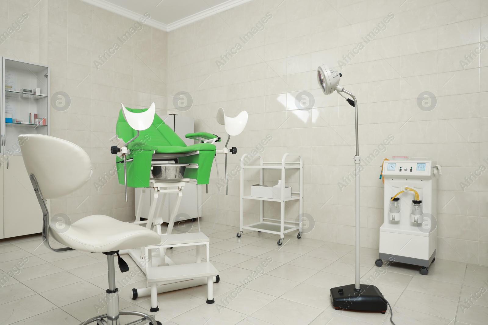 Photo of Modern gynecological office interior with examination chair and medical equipment