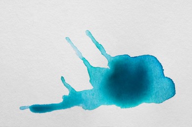 Light blue ink blots on white canvas, top view