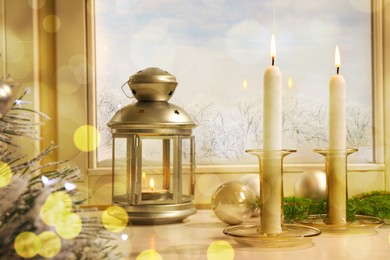 Image of Burning candles and festive decor on white window sill indoors. Christmas eve