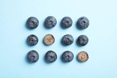 Photo of Flat lay composition with tasty blueberry on color background