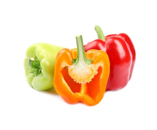 Photo of Whole and cut bell peppers on white background