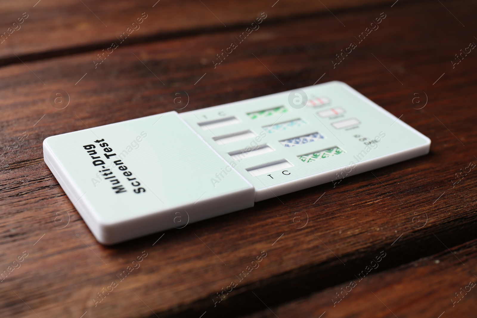 Photo of Multi-drug screen test on wooden table, closeup