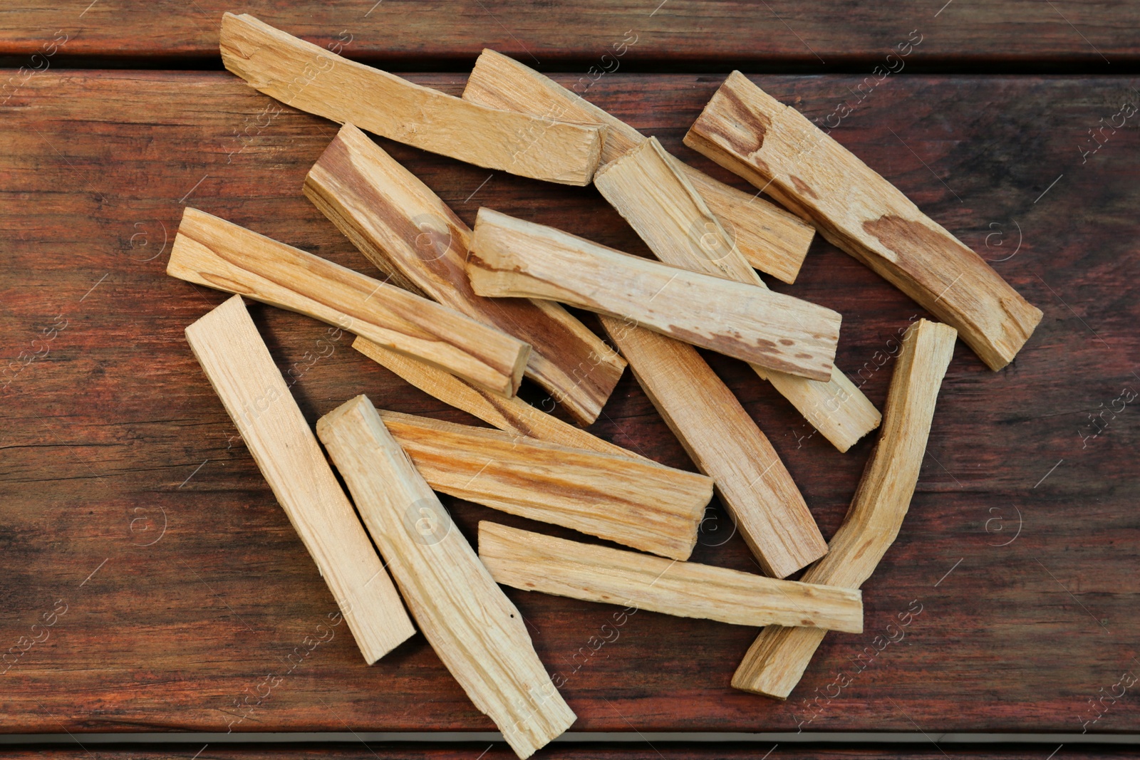Photo of Many palo santo sticks on wooden table, flat lay