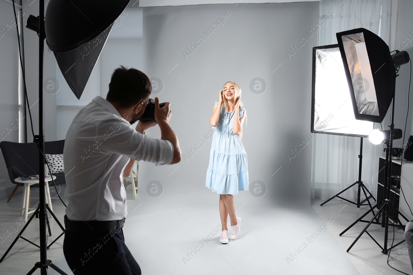 Photo of Beautiful model posing for professional photographer in studio