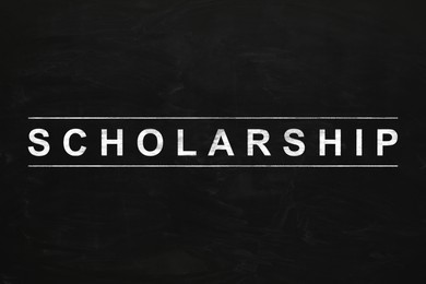 Word SCHOLARSHIP written with chalk on blackboard