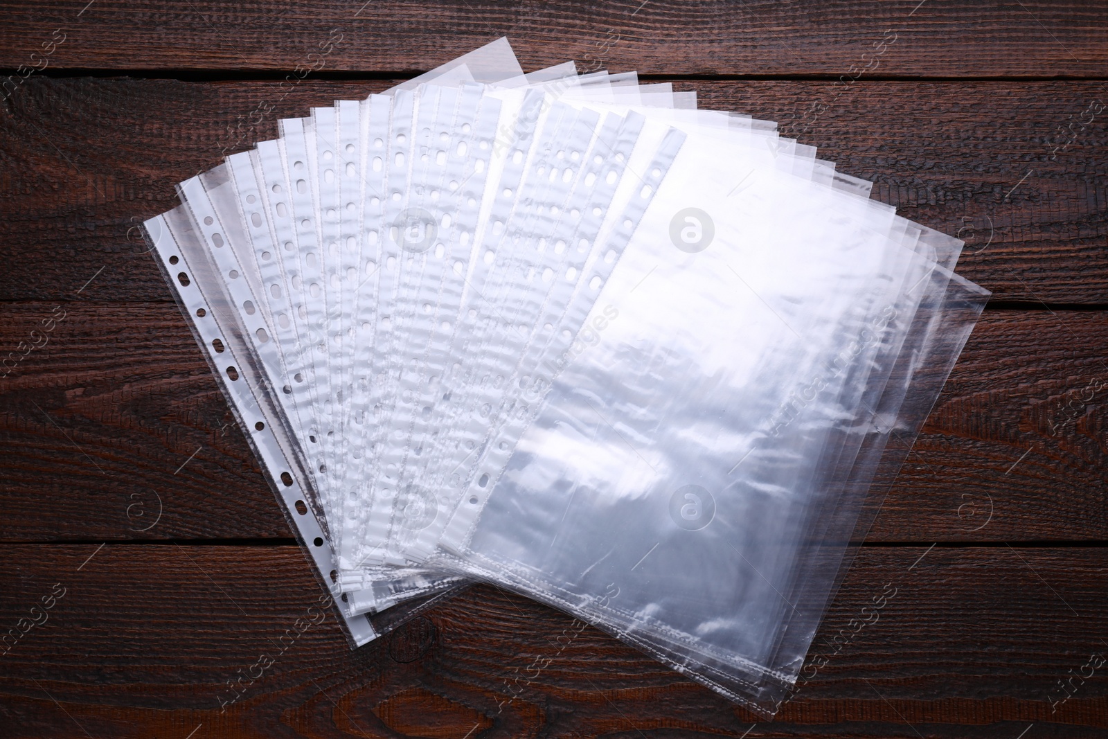 Photo of Punched pockets on wooden table, flat lay