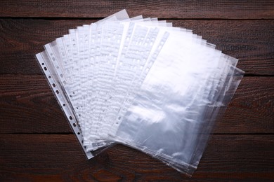 Punched pockets on wooden table, flat lay