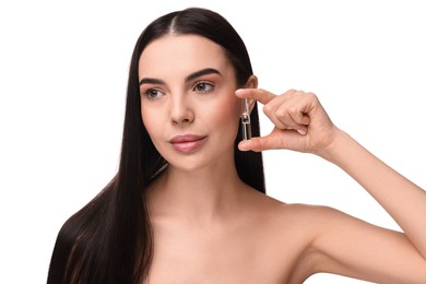 Photo of Beautiful young woman holding skincare ampoule on white background