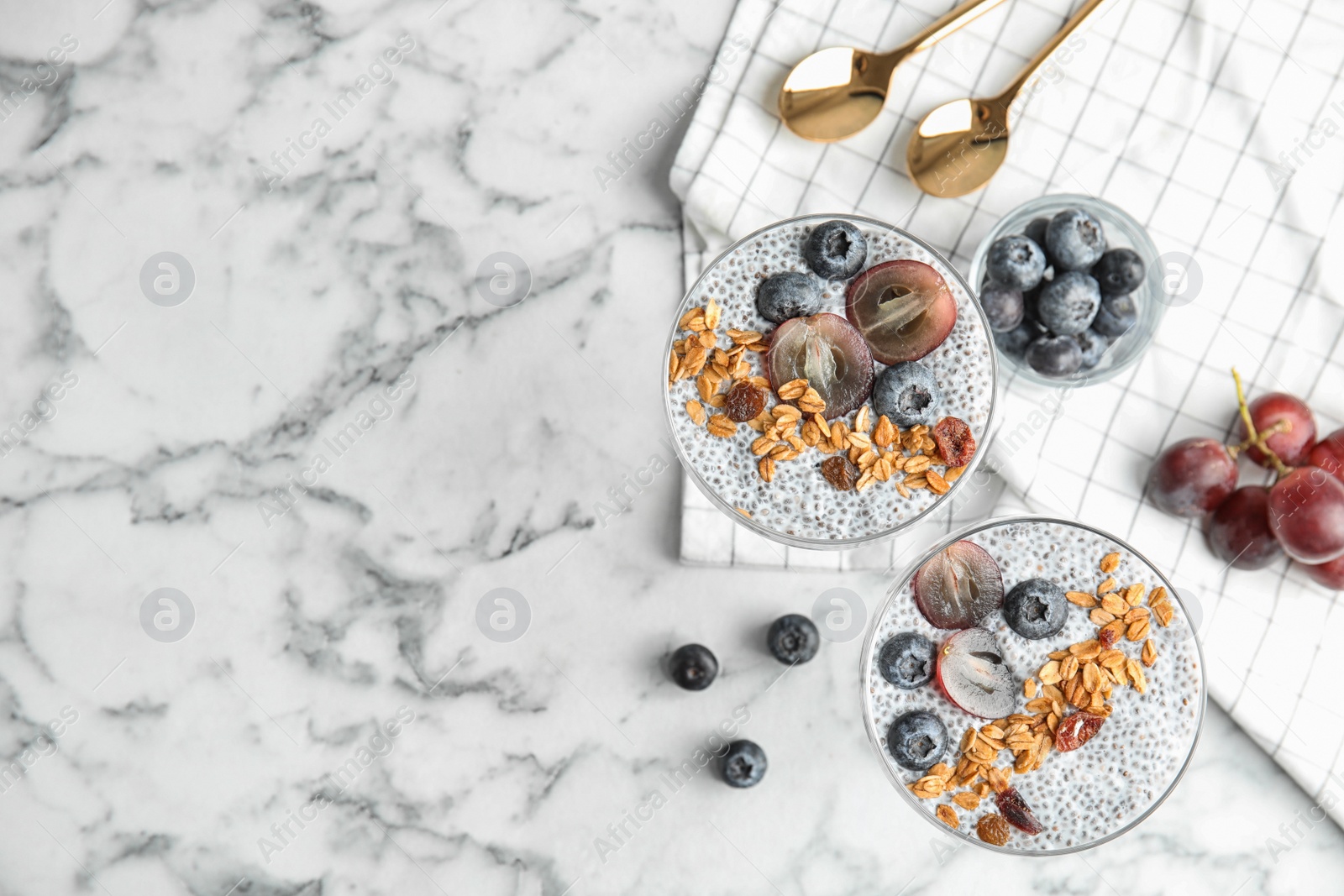Photo of Tasty chia seed pudding with granola and space for text on table, flat lay