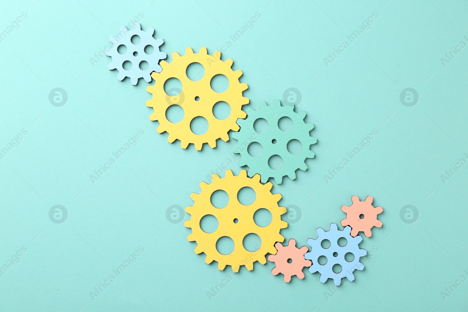 Photo of Business process organization and optimization. Scheme with colorful figures on turquoise background, top view