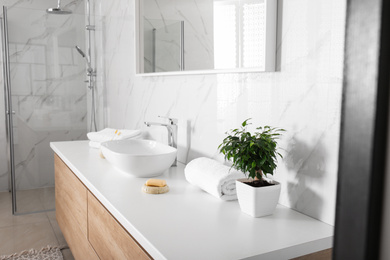 Modern mirror and vessel sink in stylish bathroom