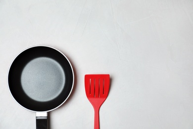 Photo of Flat lay composition with clean cookware, kitchen utensil and space for text on light background