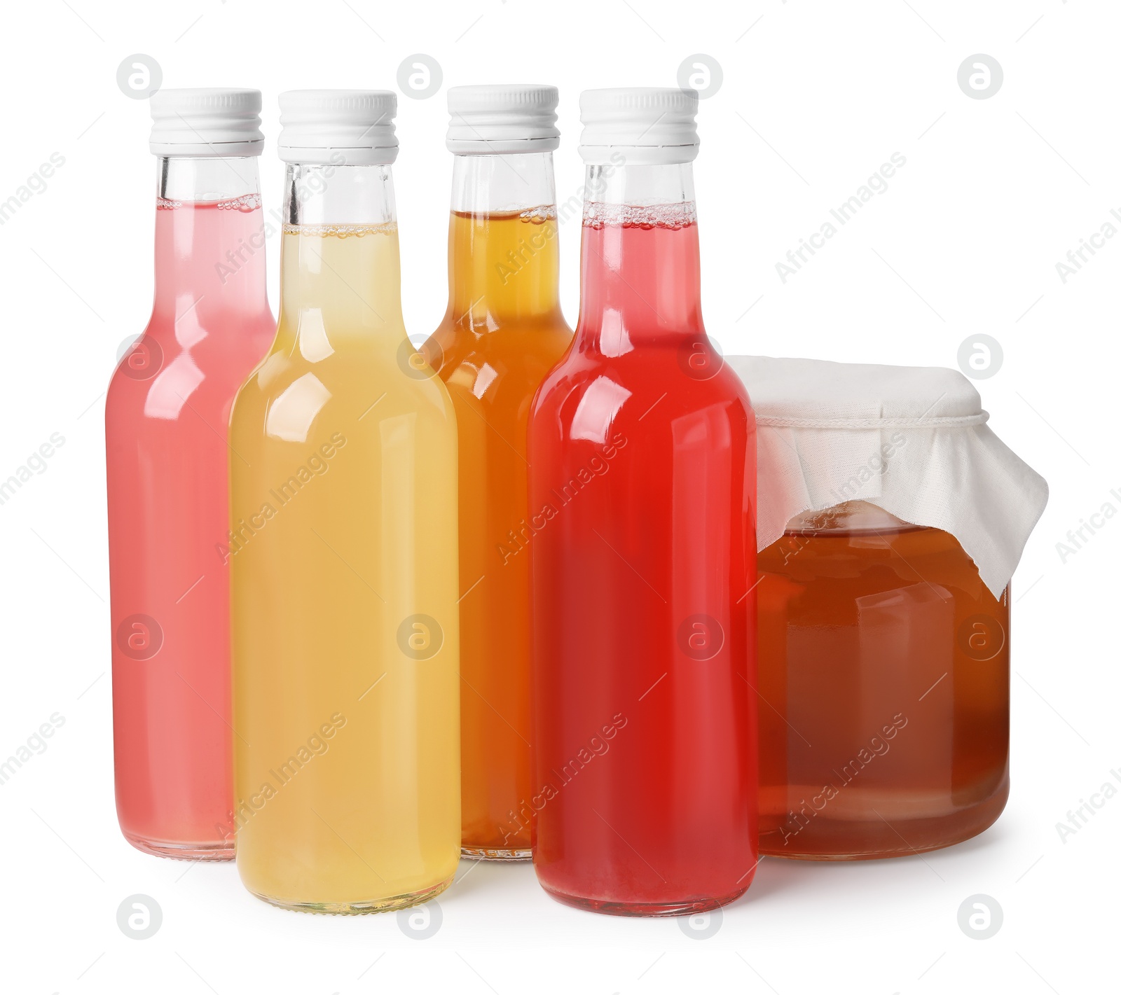 Photo of Delicious kombucha in glass bottles and jar isolated on white