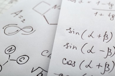 Photo of Sheets of paper with different mathematical formulas, closeup