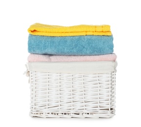 Folded towels in wicker basket on white background. Laundry day