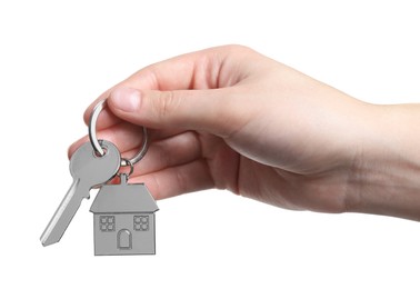 Woman holding key with keychain in shape of house isolated on white, closeup