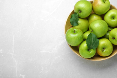 Ripe juicy green apples on white table, top view. Space for text