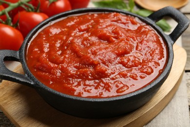 Photo of Homemade tomato sauce in bowl on table, closeup