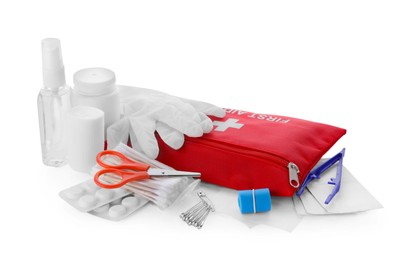 Photo of Red first aid kit, scissors, pins, gloves, cotton buds, pills, hand sanitizer, plastic forceps and elastic bandage isolated on white