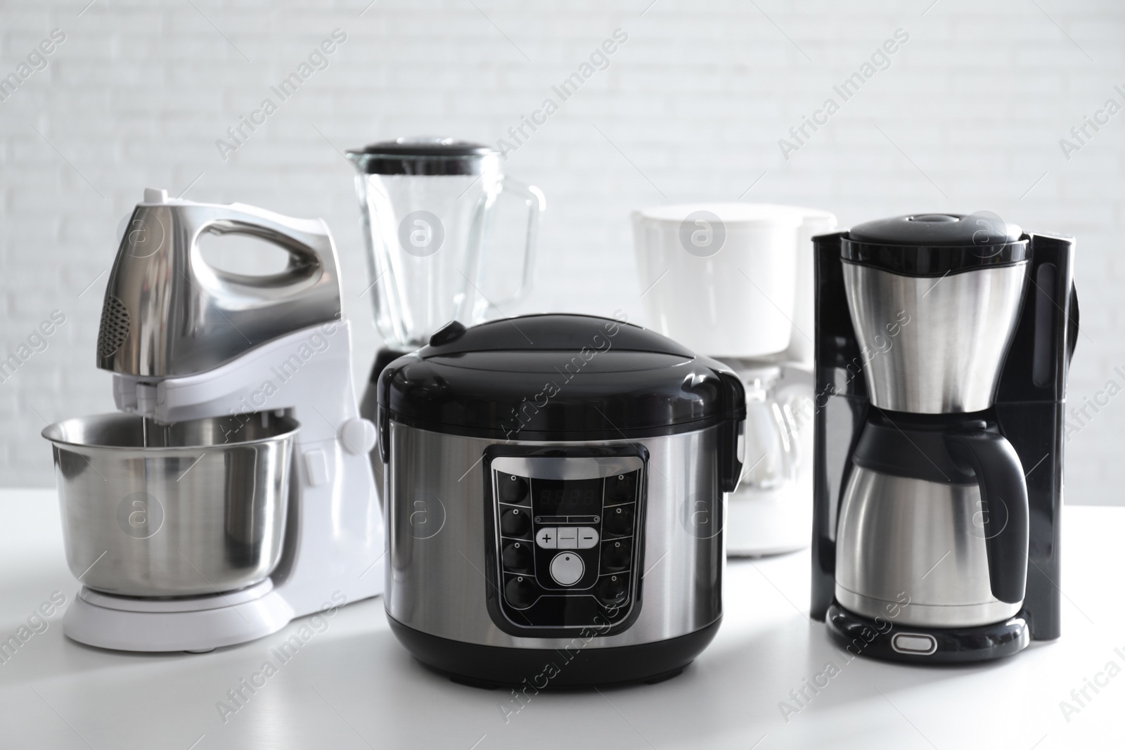 Photo of Set of modern home appliances on white table