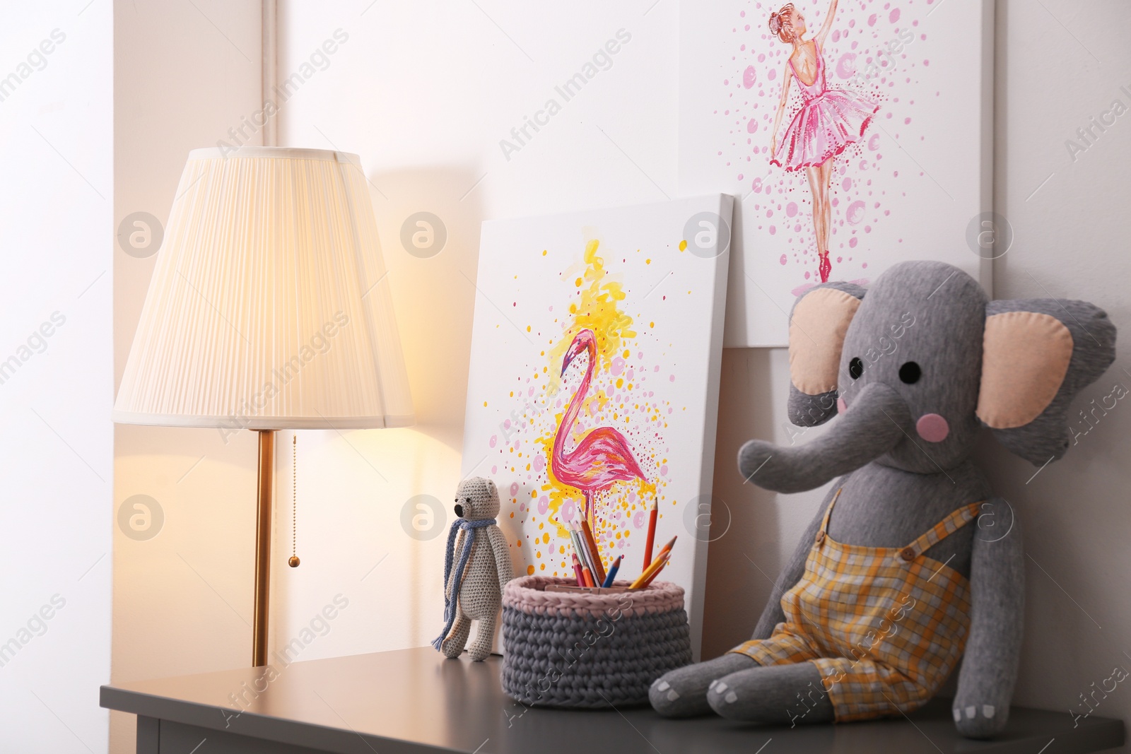 Photo of Pictures and toys on table in children's room. Interior design