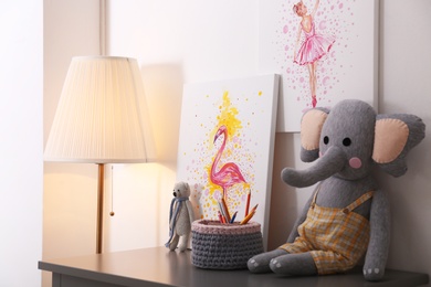 Pictures and toys on table in children's room. Interior design