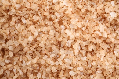 Photo of Brown sea salt as background, top view. Spa treatment