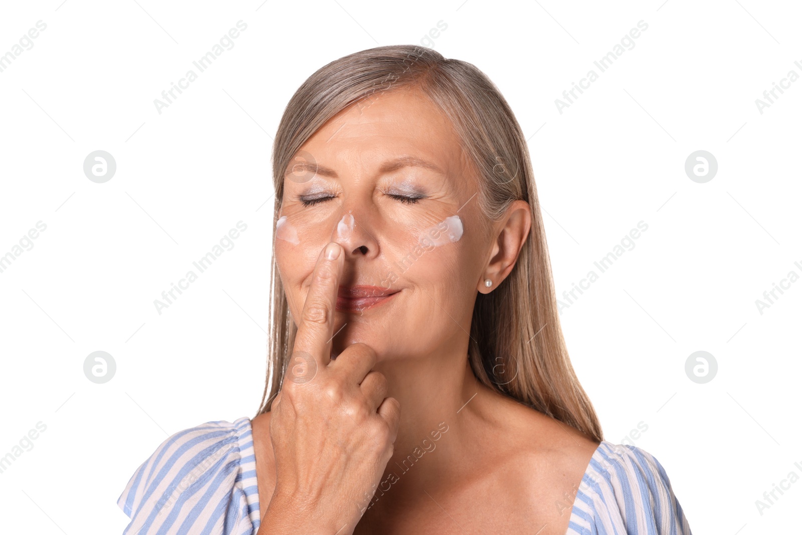 Photo of Beautiful senior woman applying sun protection cream onto her face isolated on white