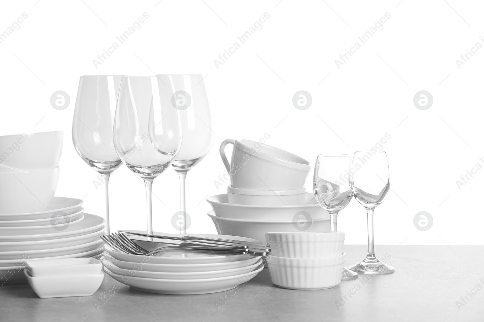 Photo of Set of clean dishes on white background