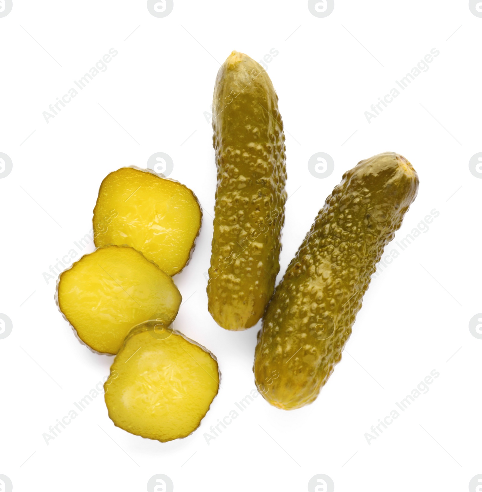 Photo of Tasty sliced and whole pickled cucumbers on white background, top view