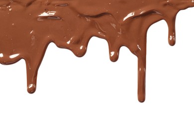 Photo of Tasty melted milk chocolate pouring down on white background