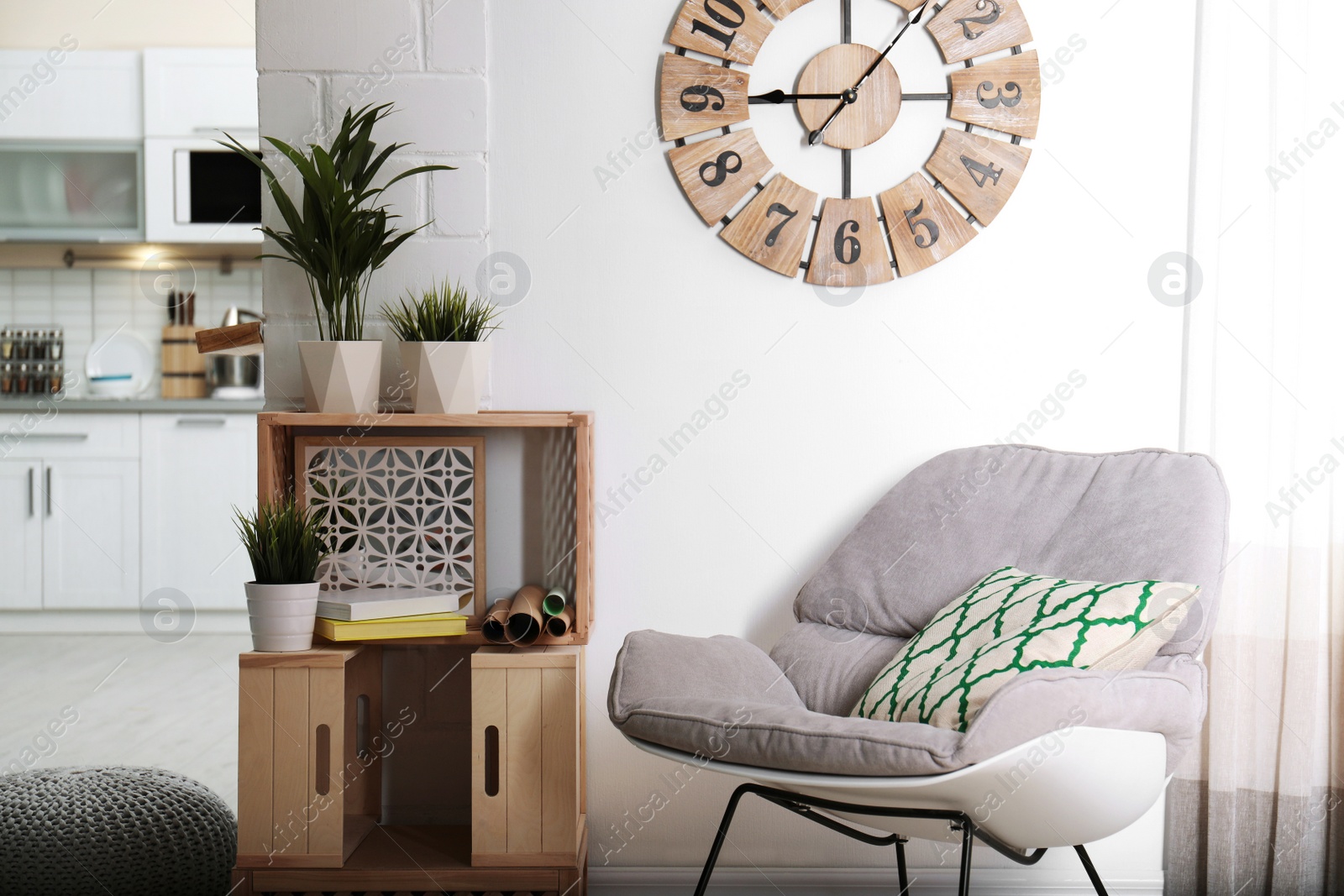 Photo of Rocking chair and wooden crates in room interior. Eco style