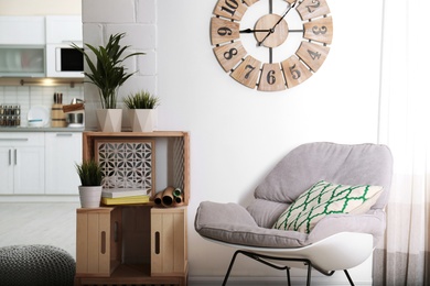 Rocking chair and wooden crates in room interior. Eco style