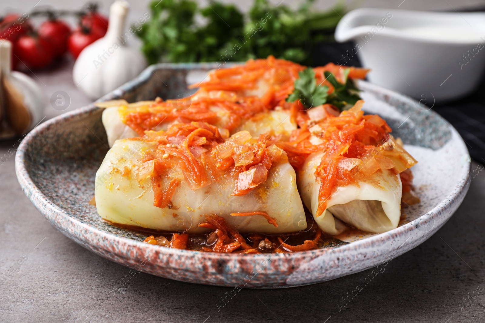 Photo of Delicious cabbage rolls served on grey table, closeup