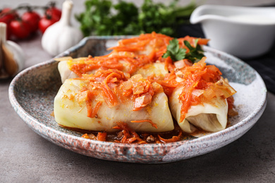 Photo of Delicious cabbage rolls served on grey table, closeup