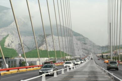 Photo of View of cars on modern bridge near mountain