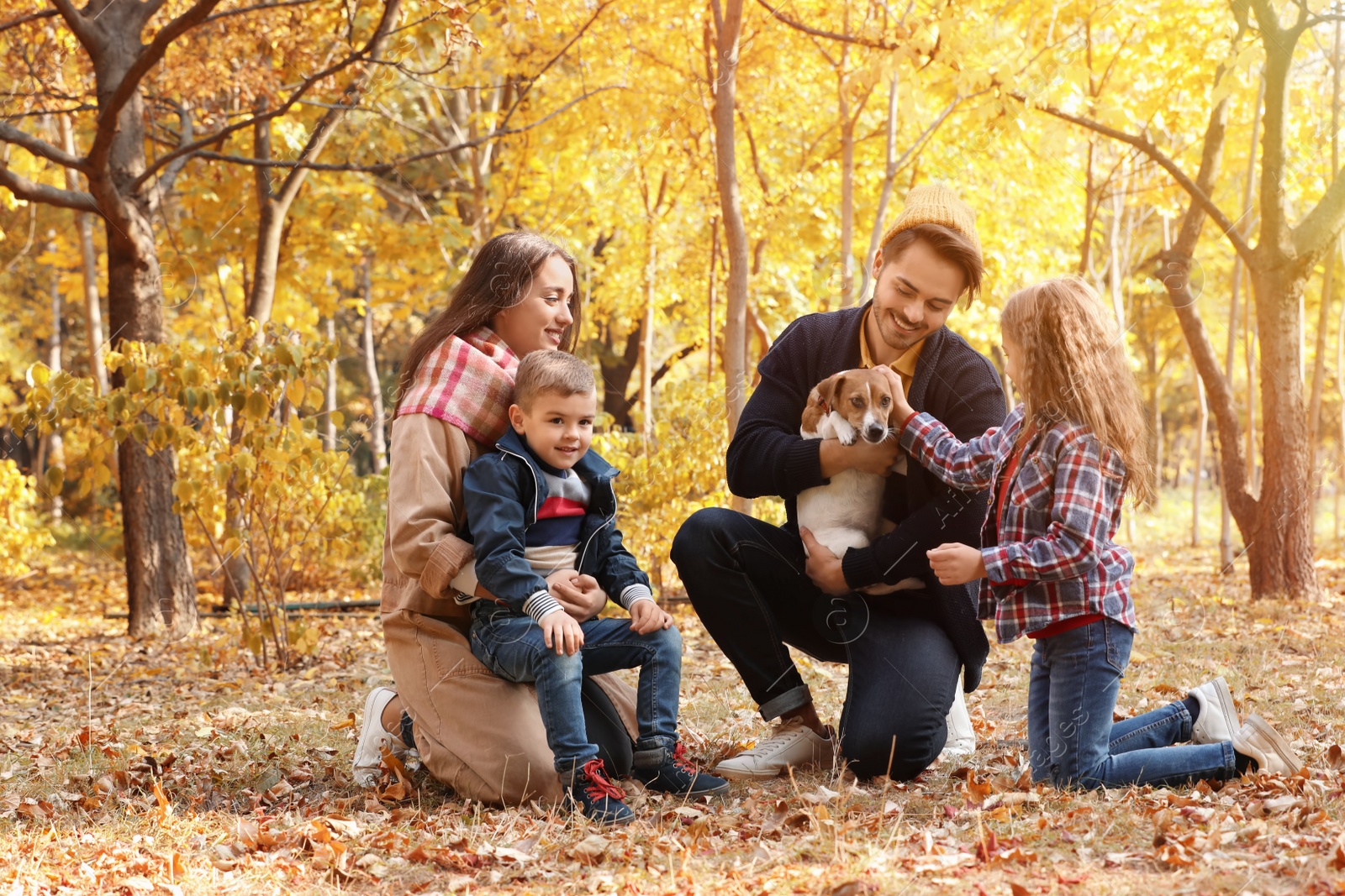 Photo of Happy family with children and dog in park. Autumn walk