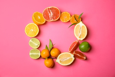 Frame made of different citrus fruits on color background, top view. Space for text