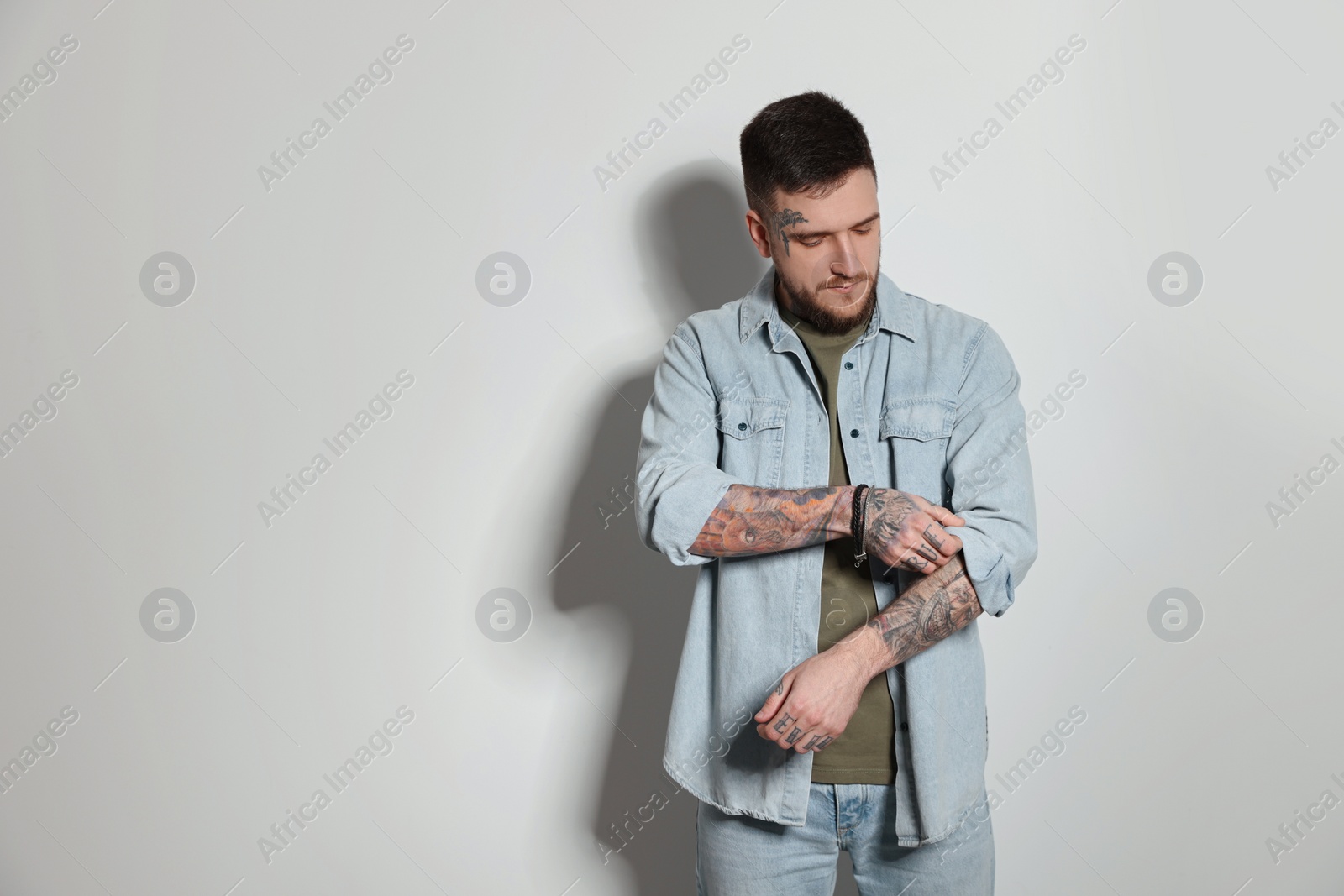 Photo of Handsome hipster man on light grey background. Space for text